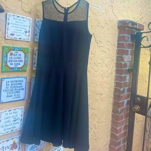 Classy short A-line shaped evening or cocktail dress with round mesh neck.